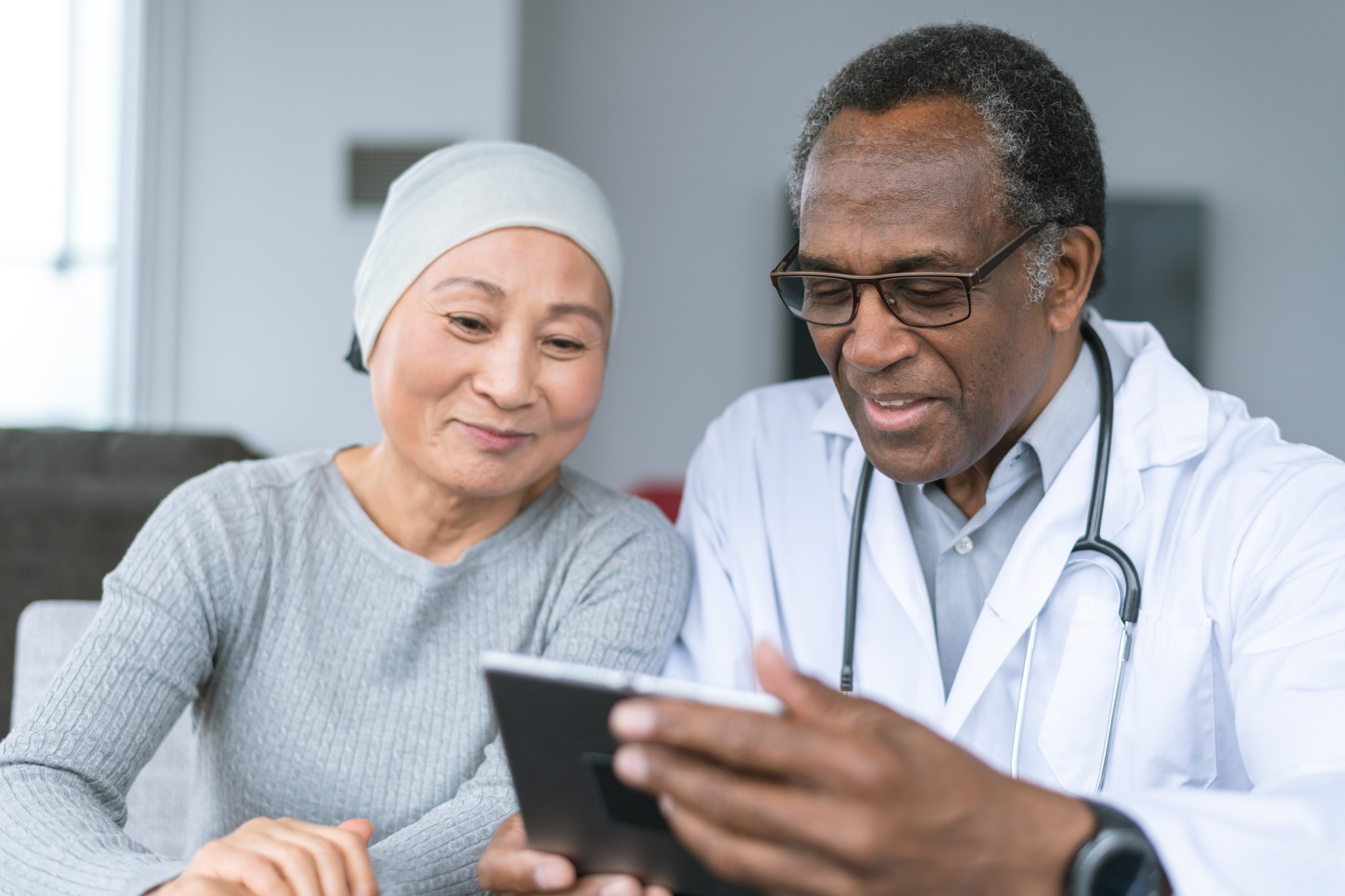 Woman with cancer reviews test results with doctor
